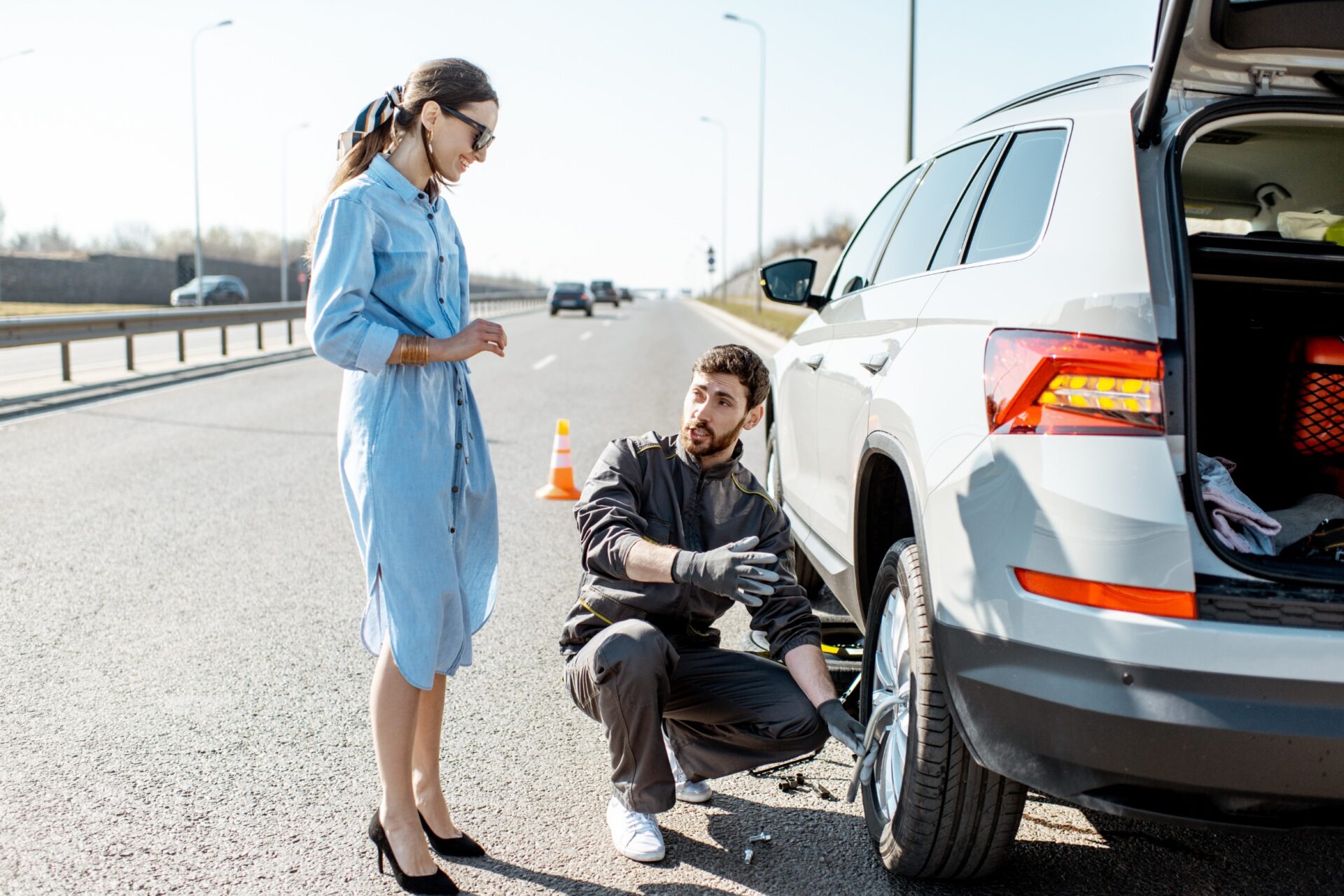 mechanic fixing car tire with rim wrench